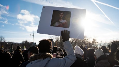 A protester holds a picture of Mahsa Amini during a rally demanding justice for the passengers of Ukraine International Airlines Flight PS752 in Ottawa on Jan. 8, marking three years since 176 people were killed on board the flight shortly after takeoff from Tehran. Cda Iran Anniversary 20230108
