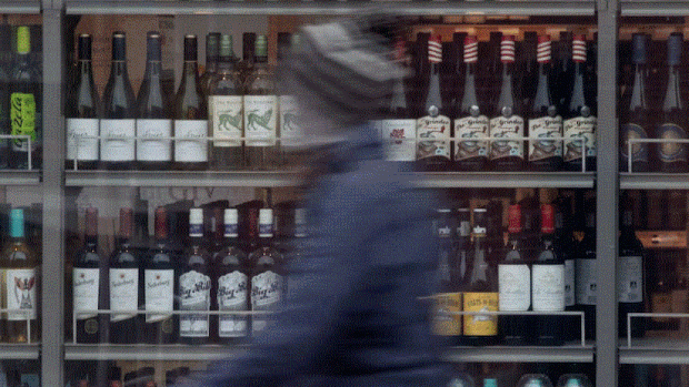 Alcohol-related deaths and hospitalizations spiked during the pandemic. Could policy have made a difference?; A person walks past shelves of bottles of alcohol on display at an LCBO in Ottawa, Thursday March 19, 2020\.