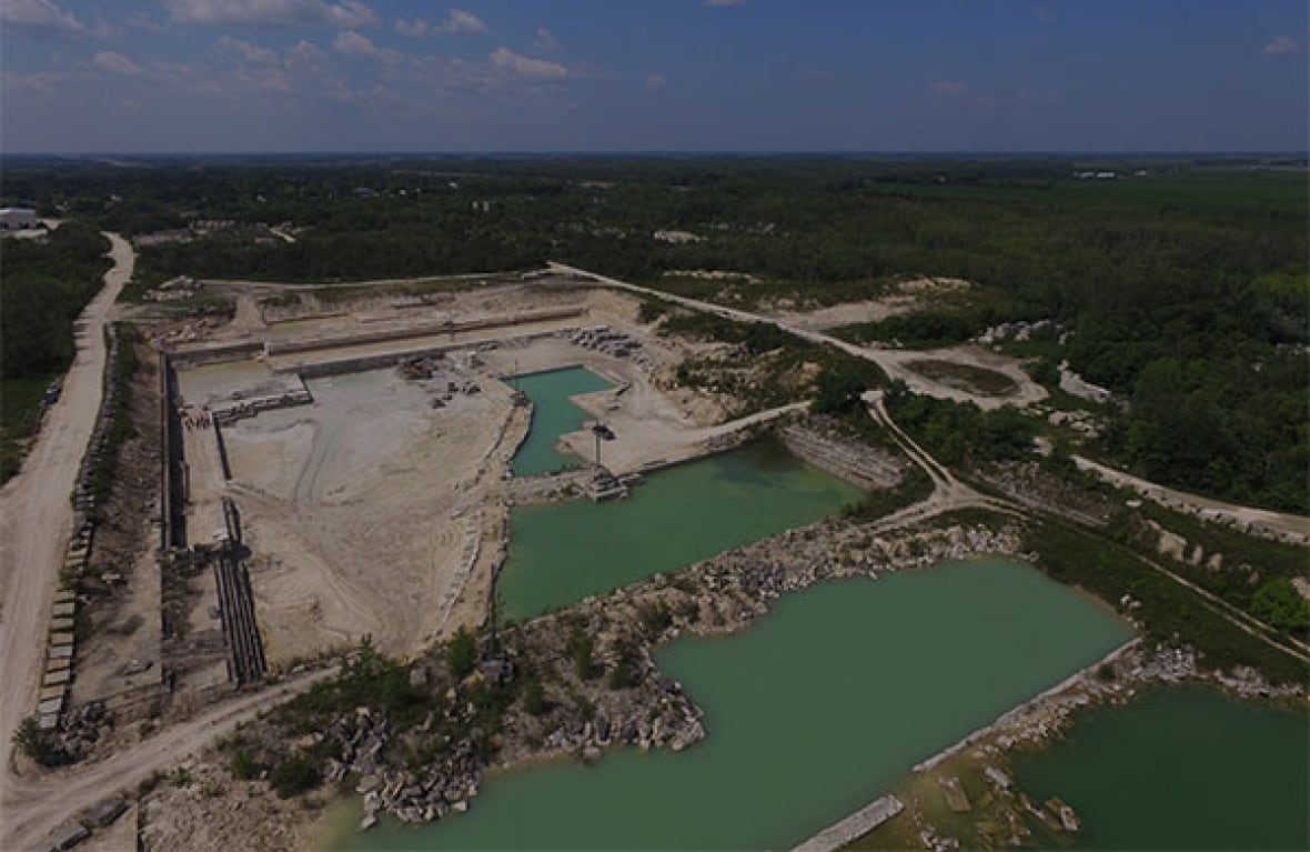 An aerial image shows a stone quarry, with areas filled with water.