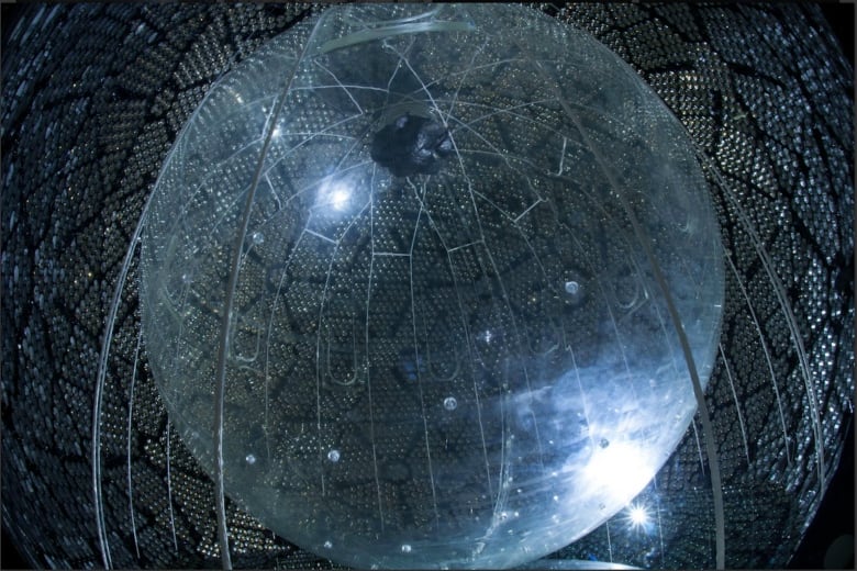 A digital image of a sphere that is blue and transparent with lines all over.