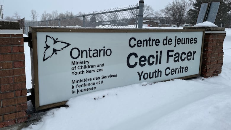 A sign next to a road that says Cecil Fracer Youth Centre.