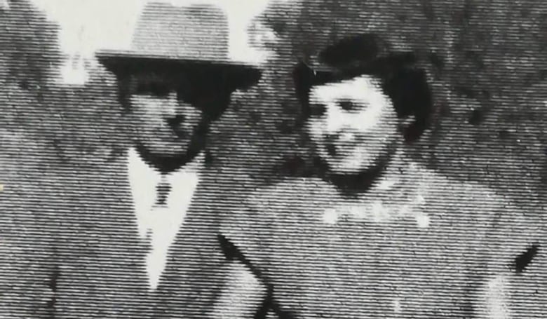 A man and woman are pictured in a black and white photo.