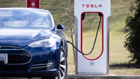 Tesla Model S vehicle plugged into a Tesla Supercharger station in Falls Church, Va.