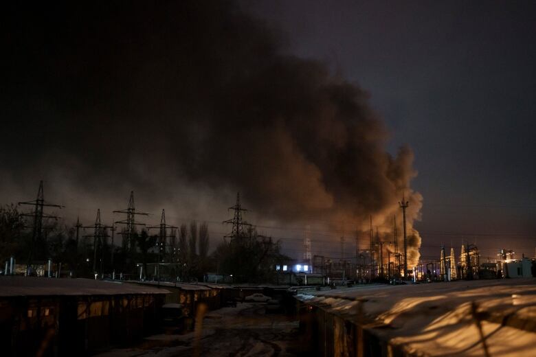 Smoke billowing outdoors in the night