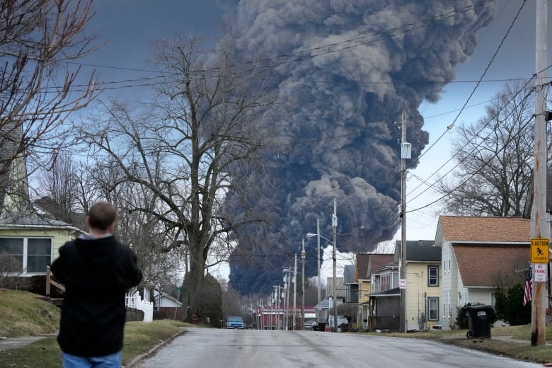 A dark grey plume of toxic smoke billows over Palestine, Ohio after a train derailed on Feb. 3, 2023.