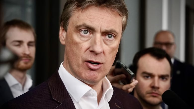 A man speaks at a microphone