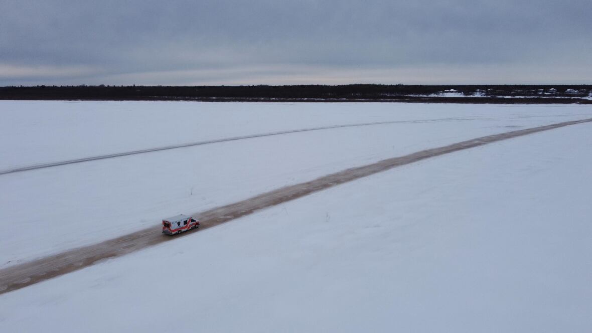 An ambulance on a snowy ice road.