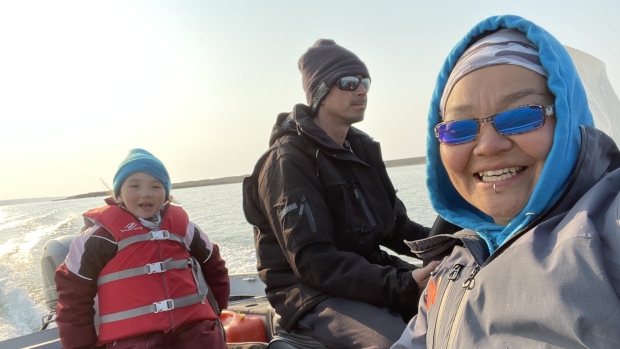 Pandemic dental delays in the N.W.T. have turned some tooth issues into emergencies;  Andrea Keogak, her daughter Hailey Kuptana, and her Hailey's dad Jeff Kuptana boating near Kellet Point off in Beaufort Delta region\.
