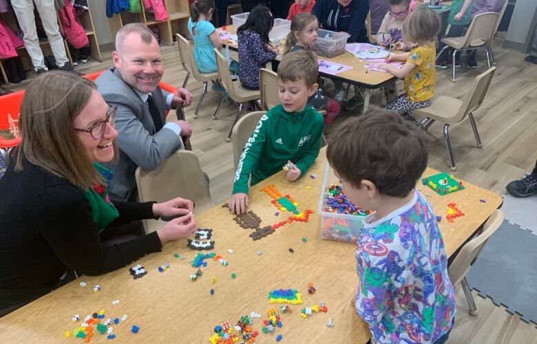 Saskatchewan Education Minister Dustin Duncan and federal Minister of Families, Children and Social Development Karina Gould meet with children at a YMCA Regina daycare on March 6, 2023. 