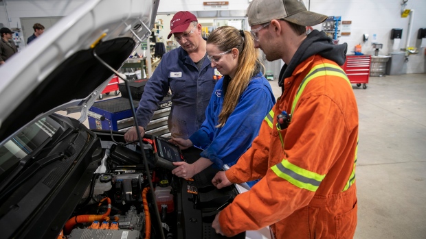 As colleges slash programs, concern grows about less choice for students, and impact to workforce; Mike Bocsik, an instructor in the automotive service technician apprentice and foundation program at Camosun College, guides students Chantal Webster, 24, and Cole Unger, 21, in the Victoria school's auto shop on Thursday, March 10, 2023\.