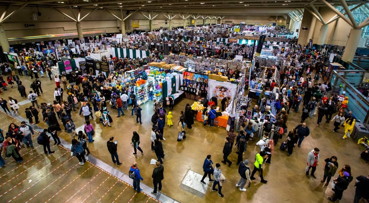 Hundreds of people can be seen attending a convention.