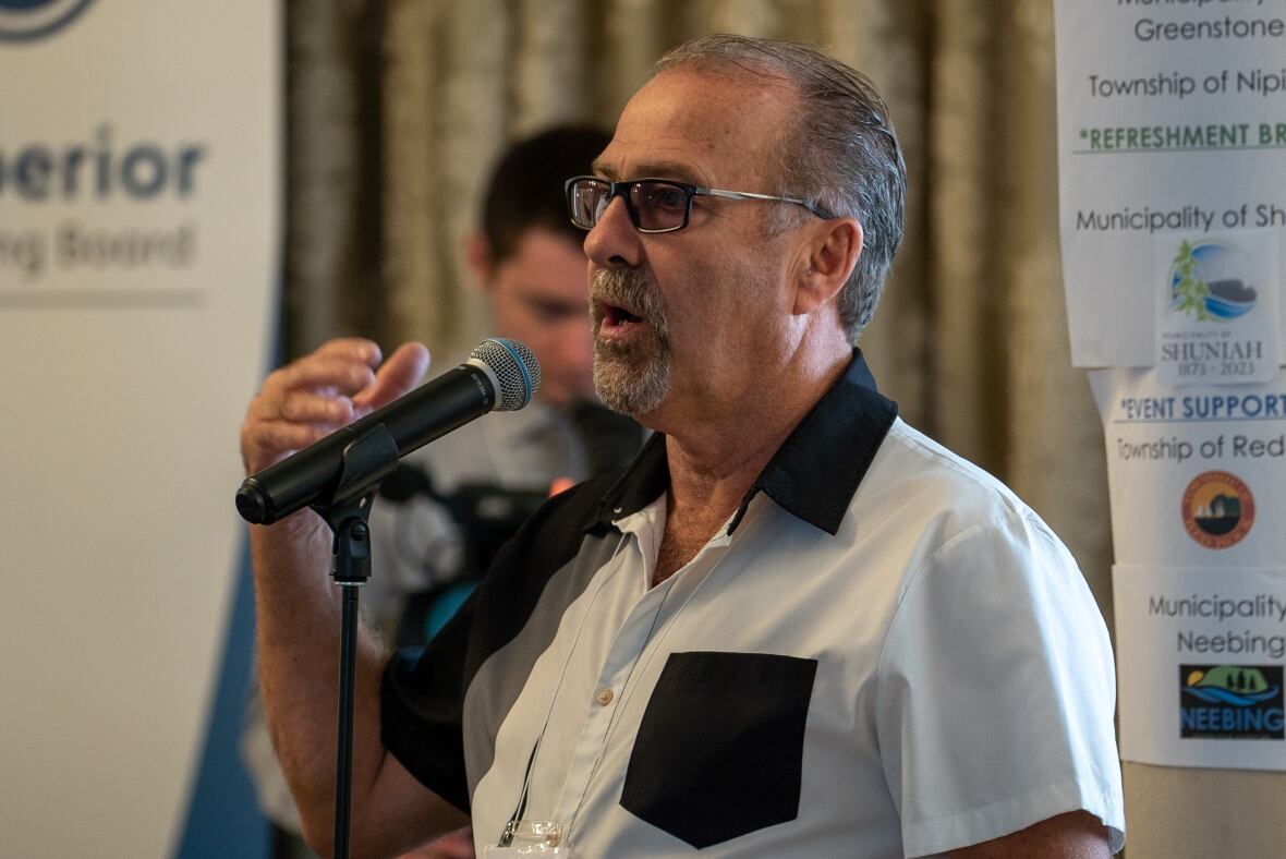 A man speaks into a microphone.