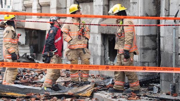 Suspect in fatal Old Montreal fire identified in court documents, but no charges laid; Investigators and firefighters are shown at the scene following a fire in Old Montreal, Saturday, March 18, 2023, that gutted the heritage building\. 