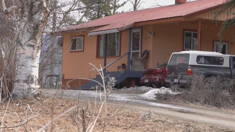 A house is pictured on a rural road.