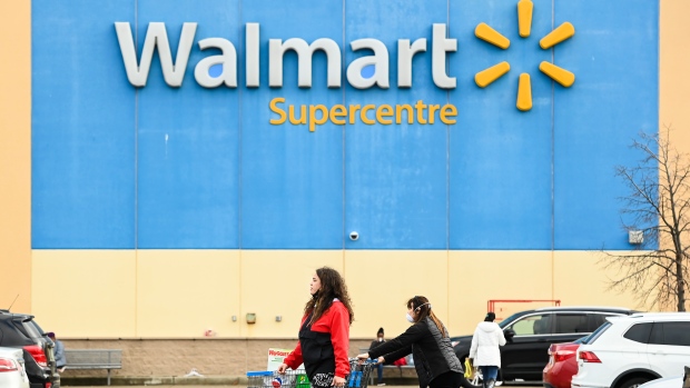 Walmart rolls out $6.5B expansion plan, including three new stores for Alberta; People leave the Walmart after shopping during the COVID-19 pandemic in Mississauga, Ont\., Thursday, Nov\. 26, 2020\.