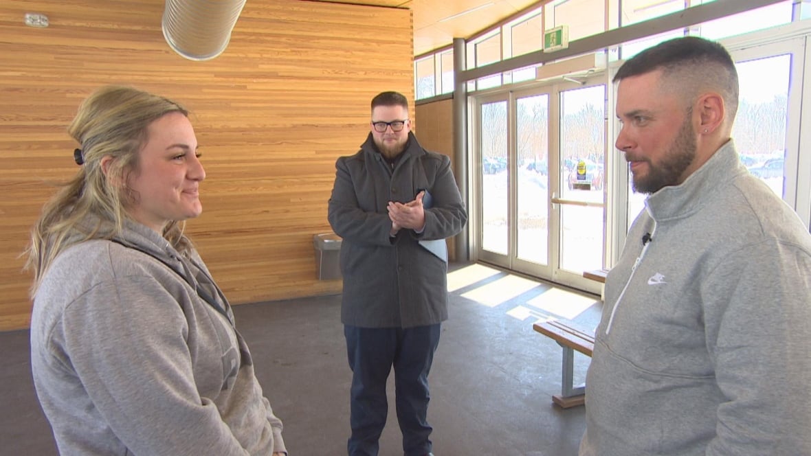 An officiant marries a couple inside a warming shack at park.