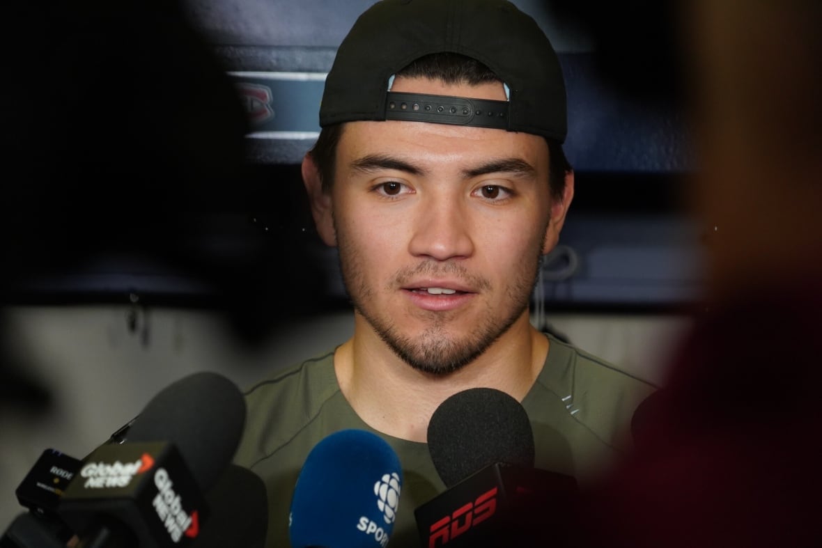Young man talks into mic.