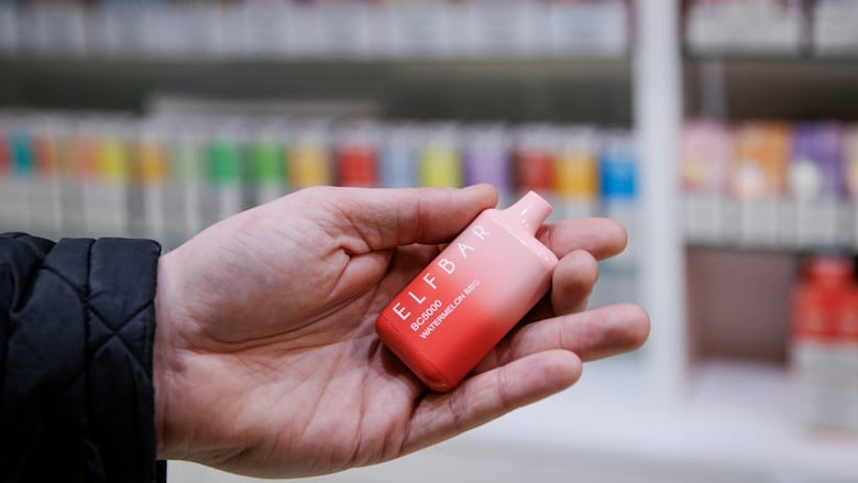 The CBC’s Adam Miller holds an Elf Bar vaping device at a downtown Toronto vape shop on April 25, 2023.