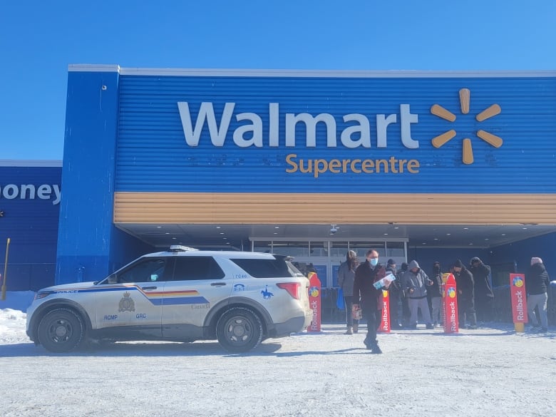 Am RCMP vehicle parked out front of a Walmart store. 