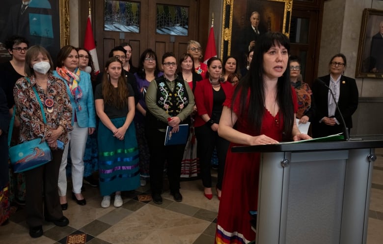 Leah Gazan, députée néo-démocrate de Winnipeg-Centre, entourée de membres des familles de femmes, de filles et de personnes bispirituelles autochtones disparues et assassinées, prend la parole lors d'une conférence de presse mardi.  Le 2 mai 2023 à Ottawa.