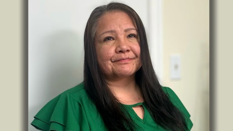 A portrait of a woman in a green dress. 