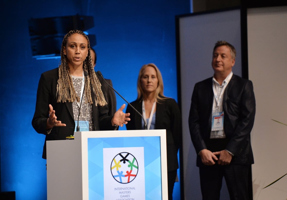 A woman speaks at a lectern.