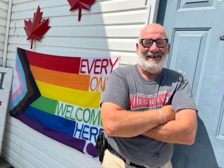 Peter Luciani displays a rainbow flag in support of thr LGTBQ community in Norwich, Ont., where town council voted to restrict flags flying on city property to those that display civic messages.