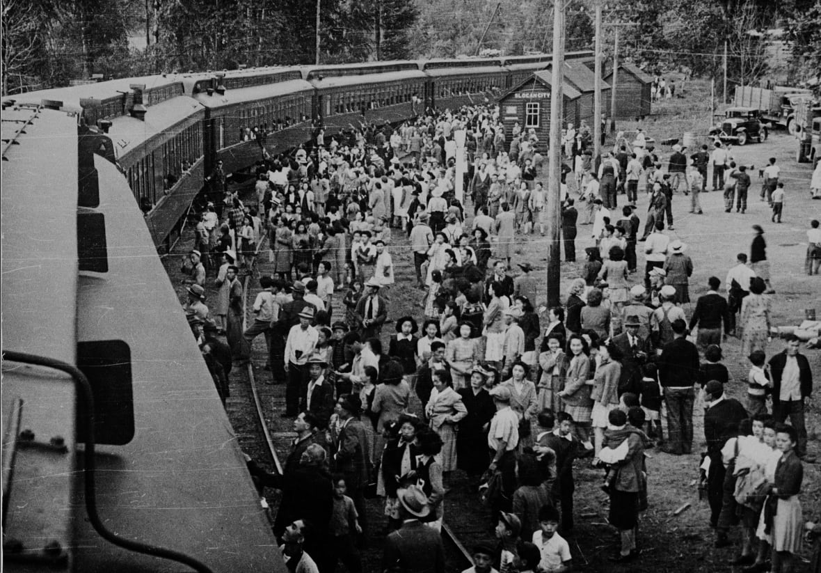 Slocan City, British Columbia; 1942--Internment Camps --Japanese-Canadians being relocated to camps in the interior of British Columbia, at train station.(CP PHOTO) 1999 (Tak Toyota National Archives of Canada)C-046356