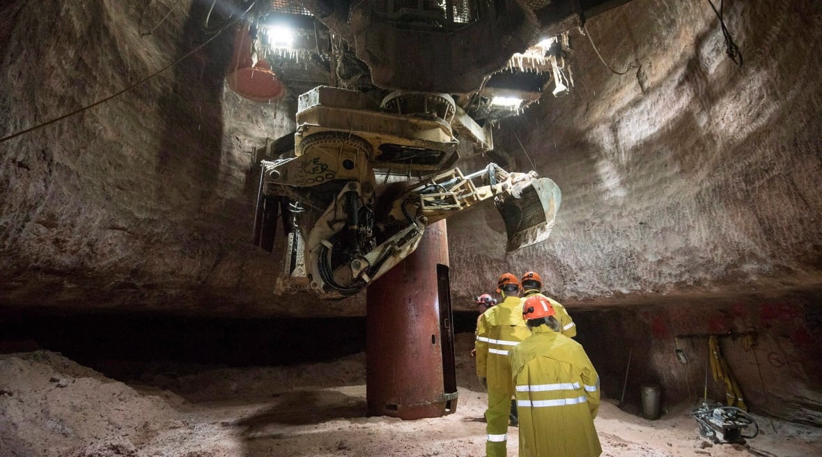 Members of the media make their way to the elevator underground at a potash mine.
