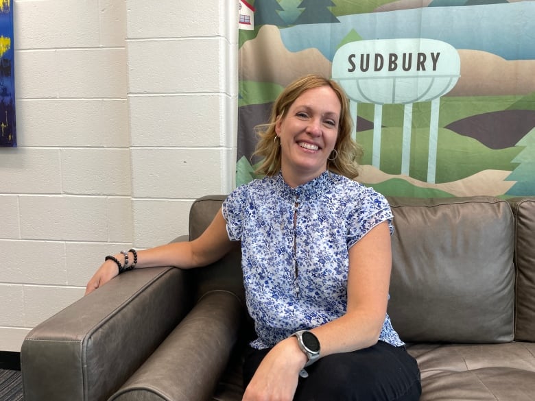 A woman sitting on a couch.