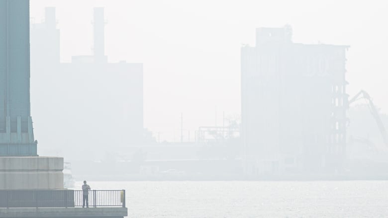 Pictured, a figure stands on a platform at the base of the Ambassador Bridge on Thursday, June 29, 2023.