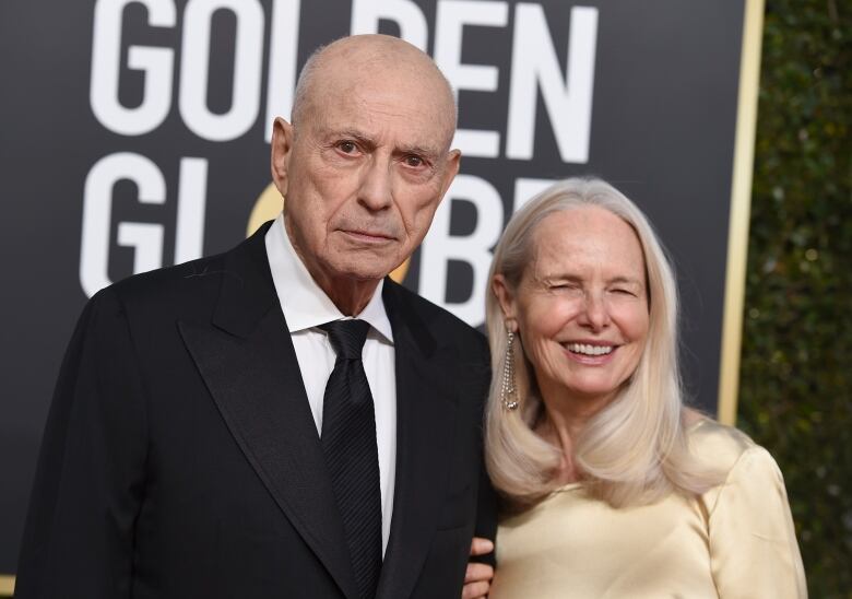 An older couple attend an awards ceremony.