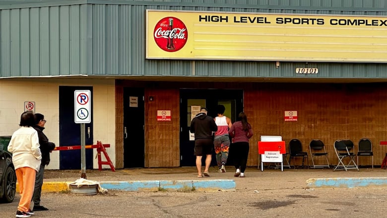 Evacuees from Yellowknife, many of whom have driven all night, head into the evacuation centre in northern Alberta.