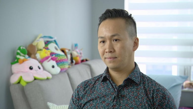 A man wearing a floral printed shirt.