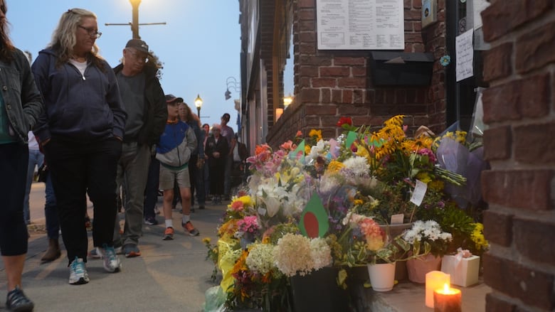 People in Owen Sound pass in front of Sharif Rahman's restaurant Sunday Aug. 28, 2023 following his funeral. Rahman was beaten and later died inside the Curry House. 