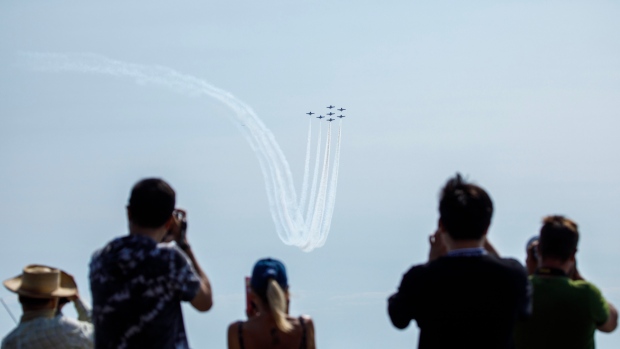 Air show, BuskerFest among Labour Day weekend events in Toronto; Spectators watch as the Snowbirds \(Canadian Forces aerobatics team\) fly over the Toronto lakeshore on Sept\. 1, 2023, during practise before the start of the Canadian International Air Show\.