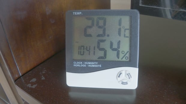 A digital thermometre showing temperature, time and humidity percentage. 