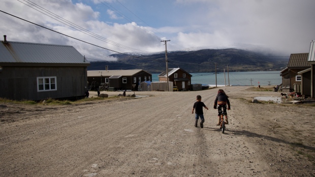 Time for new approach to TB outbreak, say some Pangnirtung, Nunavut, residents; Two children play on the street in Pangnirtung in August 2023\.