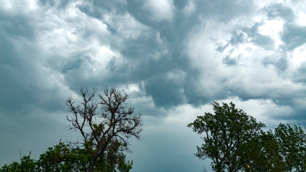 Environment Canada issues tornado warning for area around Val d'Or, Que.; Thunderstorm over Lachenaie \(From Rivière-des-Prairies\)\. See cloudy sky on 16 Jun 2022