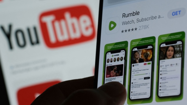 How Rumble went from a family-friendly Canadian startup to a megaphone for U.S. election deniers; This illustration photo shows the Rumble app download page on a smartphone against a YouTube logo background in Los Angeles, March 29, 2023\. - The video-sharing platform Rumble, flush with cash after a \$400 million investment in 2022, is aiming to position itself as the YouTube for conservatives even as it faces criticism for  allowing widespread misinformation and conspiracy theories\. \(Photo by Chris Delmas / AFP\) \(Photo by CHRIS DELMAS/AFP via Getty Images\)