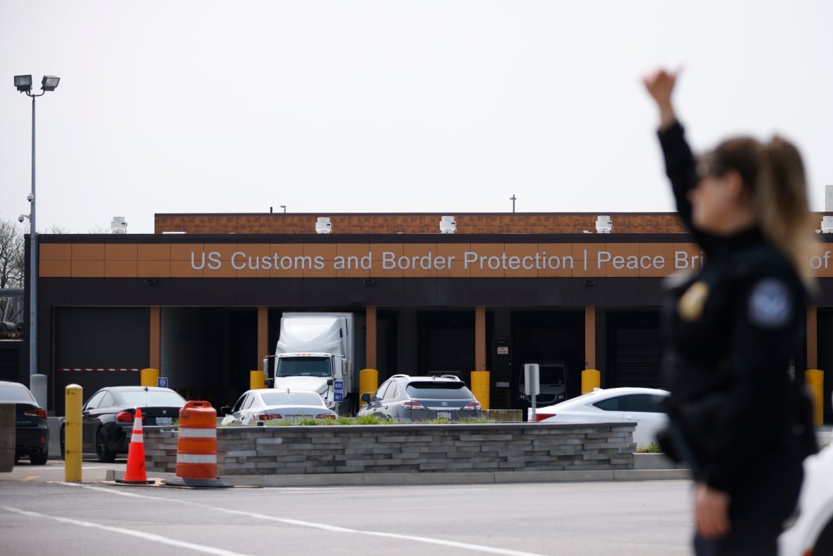 A U.S. Customs and Border Protection officer signals for vehicles at the Peace Bridge Port of Entry in Buffalo, N.Y. on May 23, 2023.