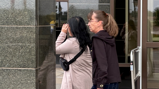 Former Moncton youth worker sentenced to 18 months for sexually exploiting teen; Bianca Chouinard, left, hides her faces from reporters as leaves the Moncton courthouse on Wednesday afternoon with a supporter after the sentencing hearing\. 