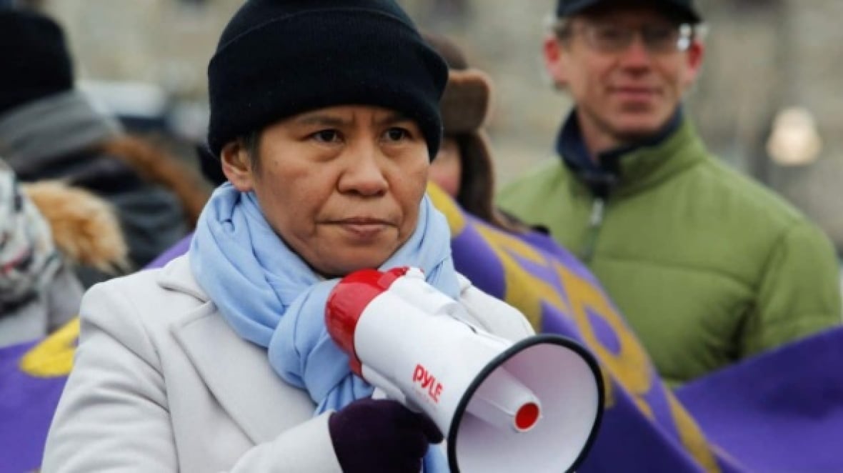 Romana Didulo holds a bullhorn.