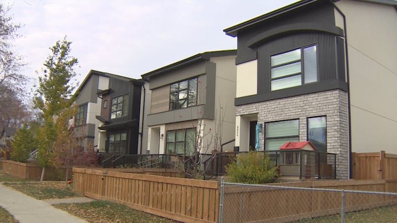 Three infill homes, all brown and beige, built in Bonnie Doon.