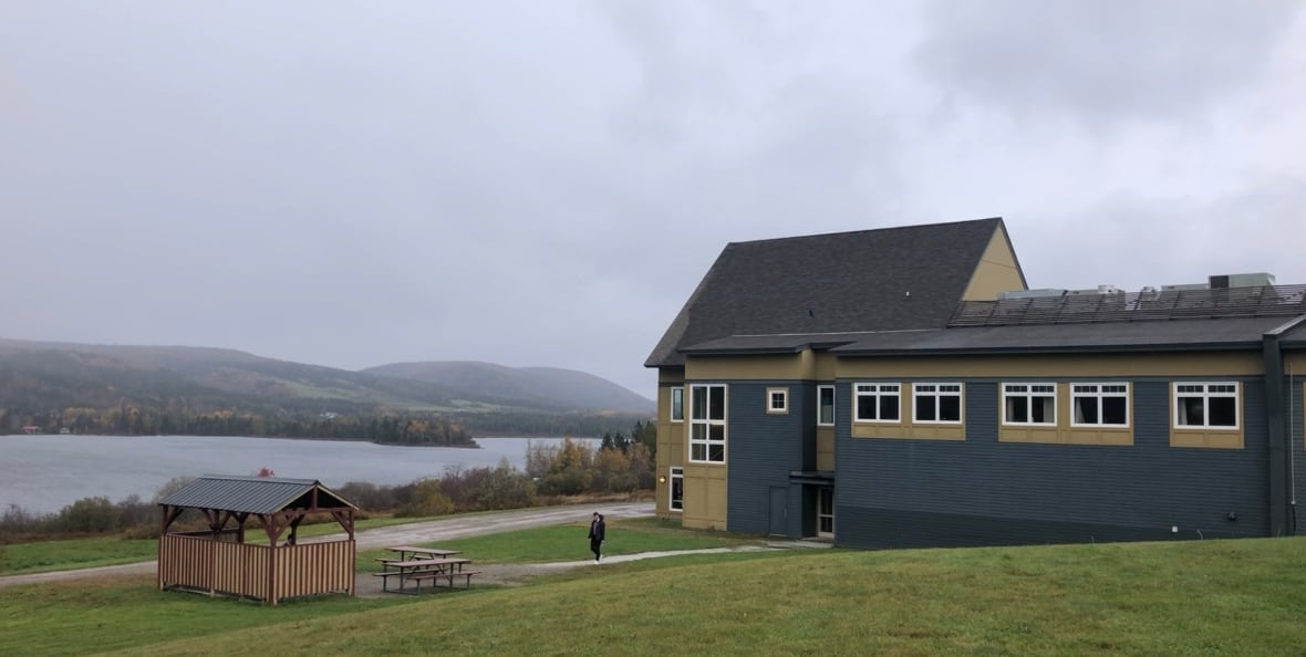 Portage Atlantic building on a hill in front of a lake.