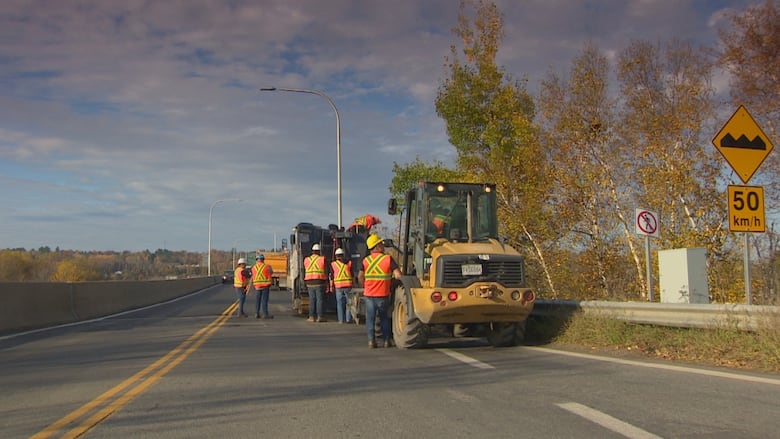 Construction crews work on the bridge