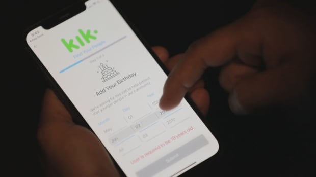 'Kyle' holds a phone showing the Kik app. Kik is an app where users can meet strangers online. Users must enter a birthdate that indicates they're over 18 years old, but there is nothing in place to verify that that information is correct. Experts say that's a security vulnerability. A person holds a phone displaying the Kik app.