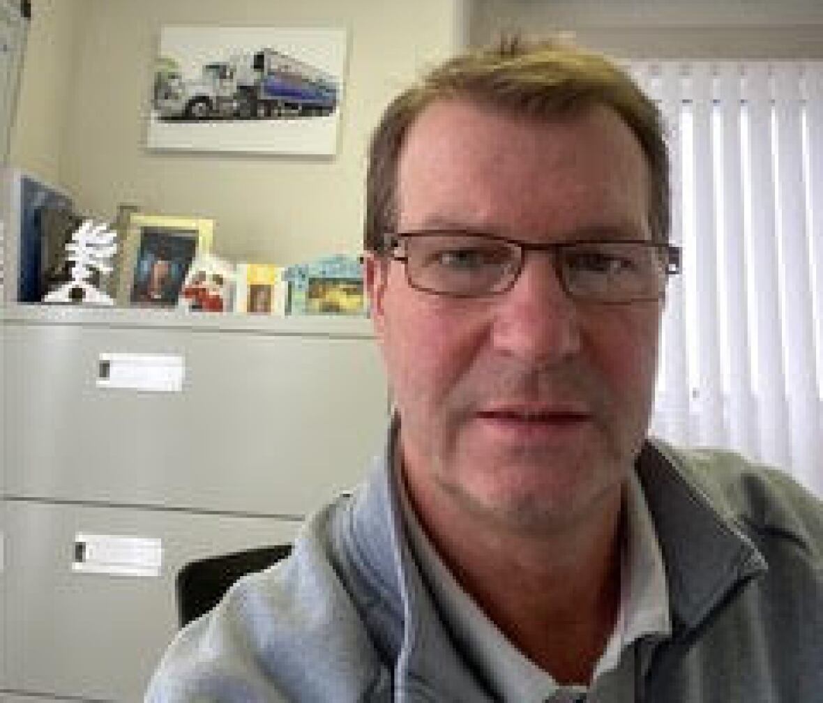 A man with glasses sitting in an office