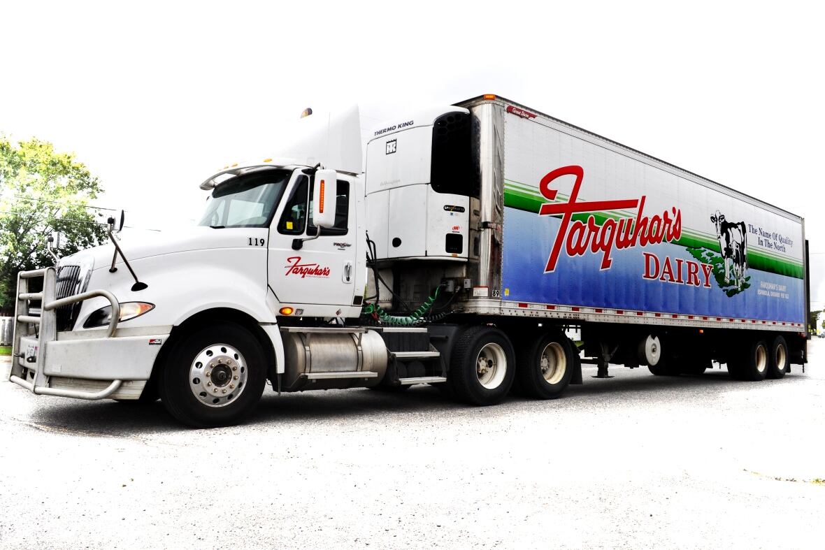 A transport truck with a logo on it that says Farquhar's Dairy.