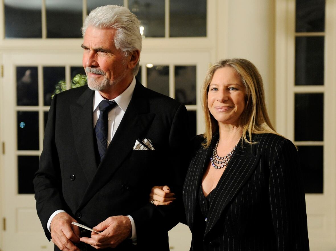 Streisand walks, holding Brolin's arm, in the White House